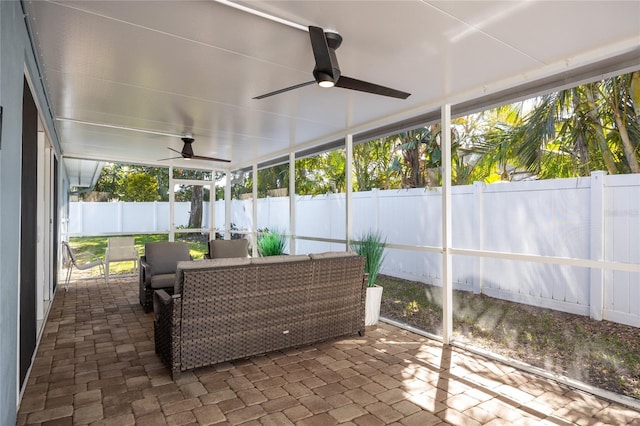 sunroom / solarium featuring ceiling fan