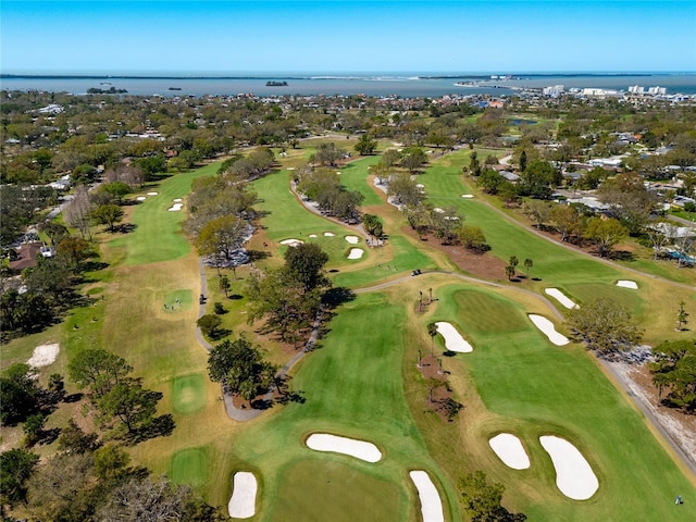 birds eye view of property with a water view and view of golf course