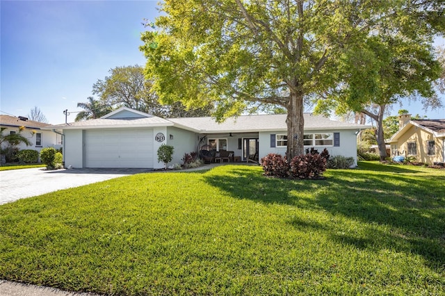 single story home featuring a garage, concrete driveway, a front yard, and stucco siding