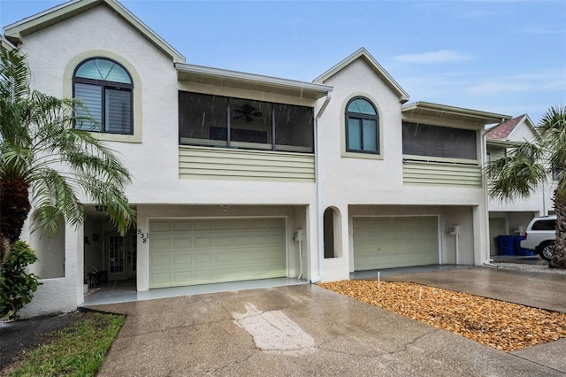 view of front of house with stucco siding, driveway, and a garage