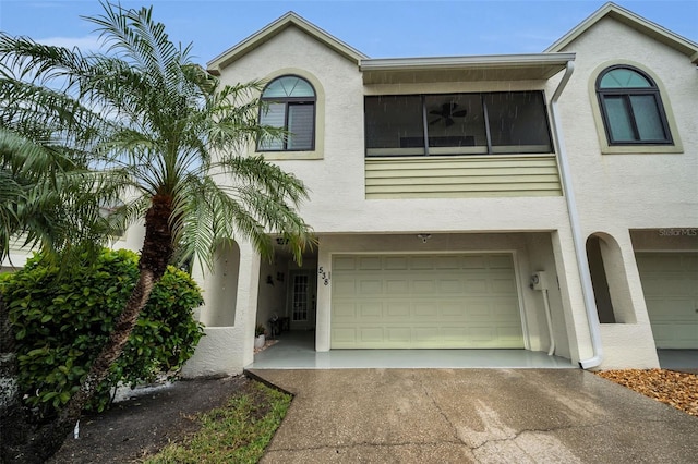 view of front of home featuring stucco siding, driveway, and a garage