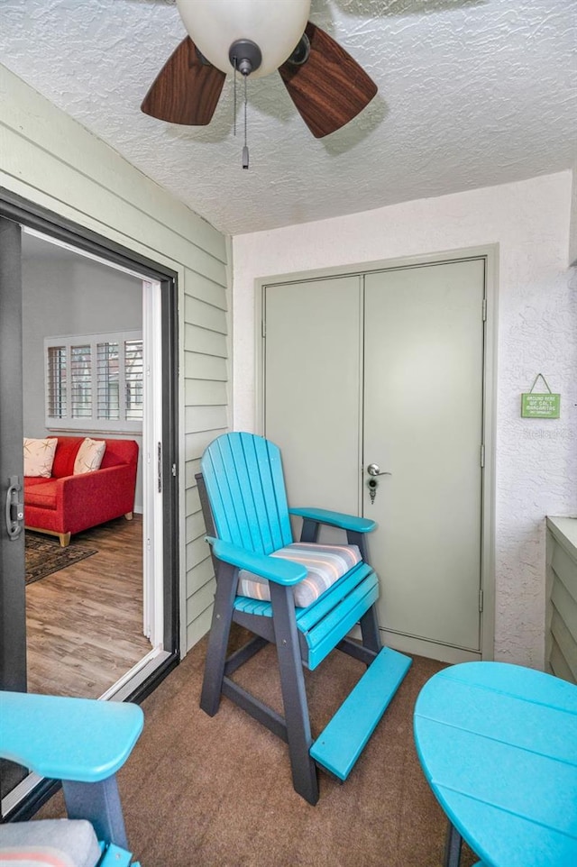 sunroom / solarium with a ceiling fan