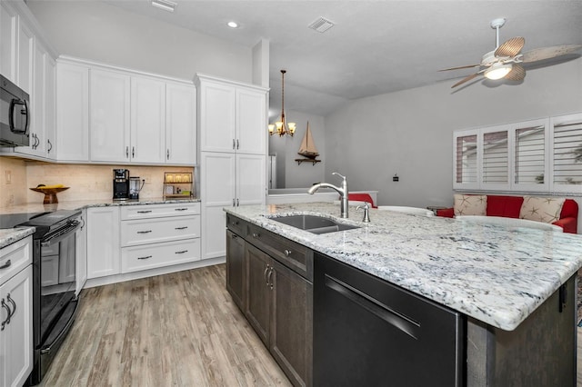 kitchen featuring a sink, black / electric stove, dishwasher, and white cabinets