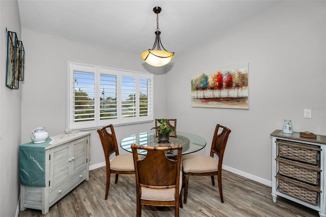 dining space featuring wood finished floors and baseboards