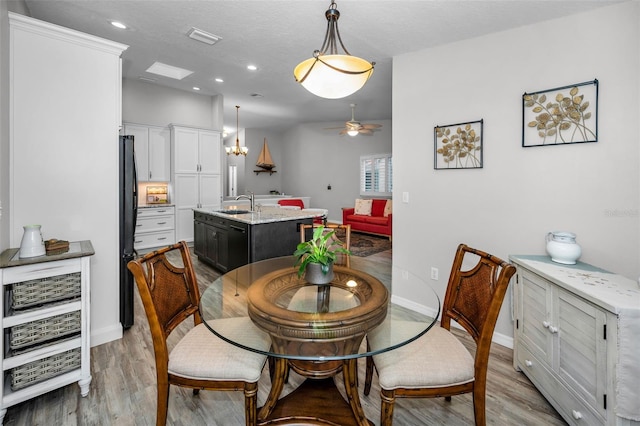 dining space featuring light wood-style flooring, recessed lighting, baseboards, and visible vents