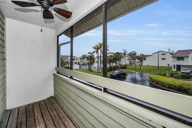 balcony with a residential view and a ceiling fan