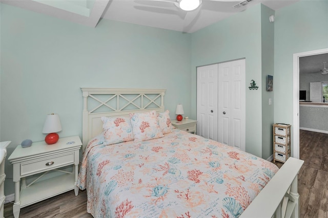 bedroom with a closet, visible vents, wood finished floors, and a ceiling fan