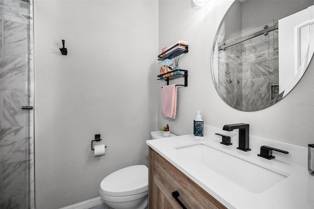 full bathroom with baseboards, vanity, toilet, and a shower stall