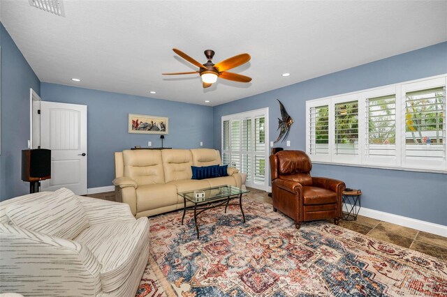 living area with visible vents, recessed lighting, baseboards, and ceiling fan