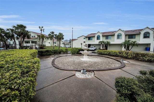 view of property's community featuring a residential view and fence