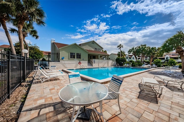 pool featuring a patio area and fence