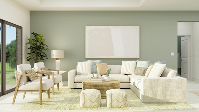 living room featuring light wood-style flooring and a raised ceiling