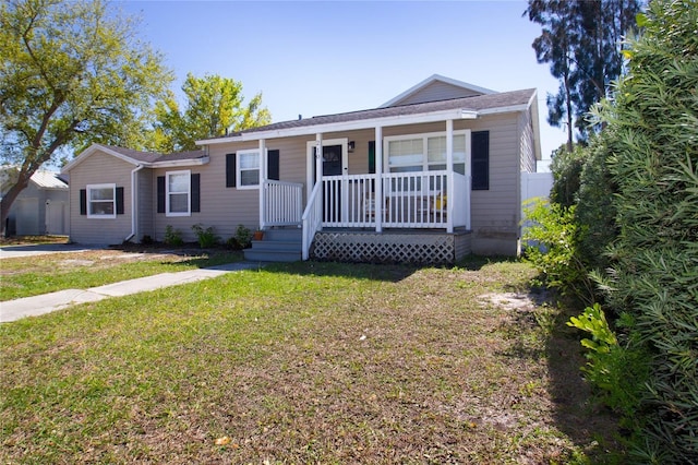 view of front of home with a porch and a front lawn