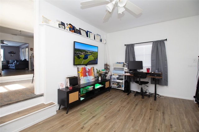 home office featuring baseboards, wood finished floors, and a ceiling fan