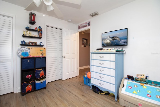 game room with visible vents, wood finished floors, and a ceiling fan