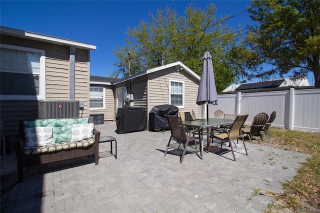 view of patio with outdoor dining area, area for grilling, outdoor lounge area, and fence