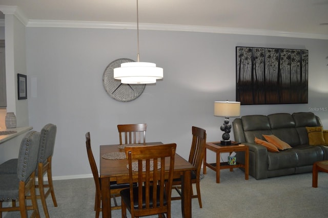 dining area with carpet flooring, baseboards, and ornamental molding