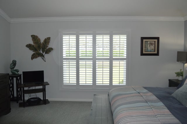 carpeted bedroom featuring baseboards and ornamental molding