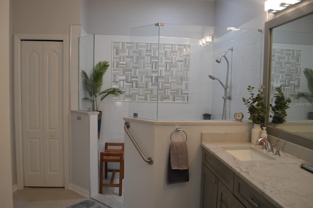 bathroom featuring a closet, a walk in shower, and vanity