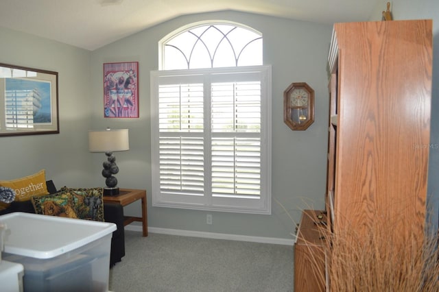 sitting room featuring vaulted ceiling, carpet flooring, and baseboards