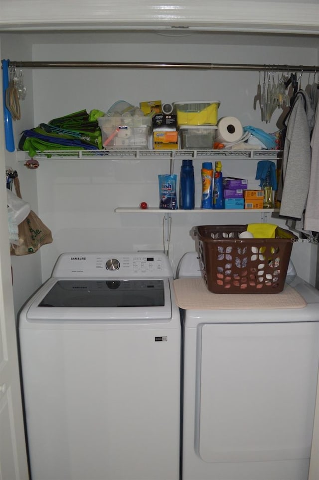 clothes washing area with laundry area and washing machine and clothes dryer