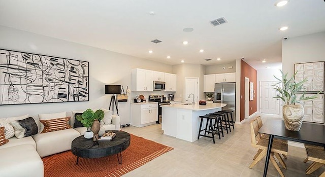 living area with visible vents and recessed lighting