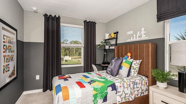 carpeted bedroom featuring baseboards