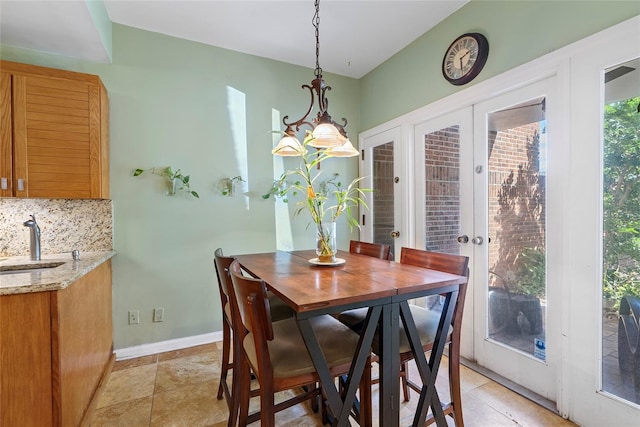 dining room with french doors and baseboards