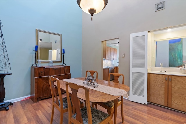 dining area with visible vents, baseboards, and light wood-style flooring