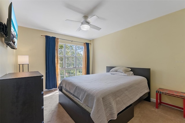 carpeted bedroom with baseboards and ceiling fan