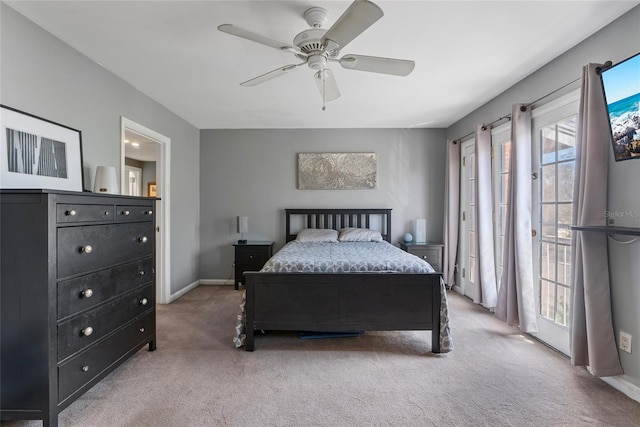 carpeted bedroom with access to exterior, ceiling fan, and baseboards