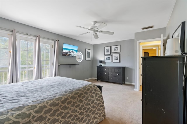 carpeted bedroom with a ceiling fan, access to exterior, baseboards, and visible vents