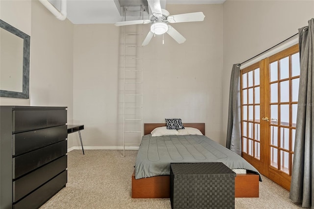 bedroom featuring french doors, baseboards, light colored carpet, and a ceiling fan