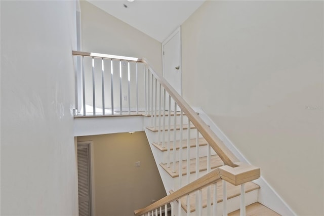 staircase with vaulted ceiling