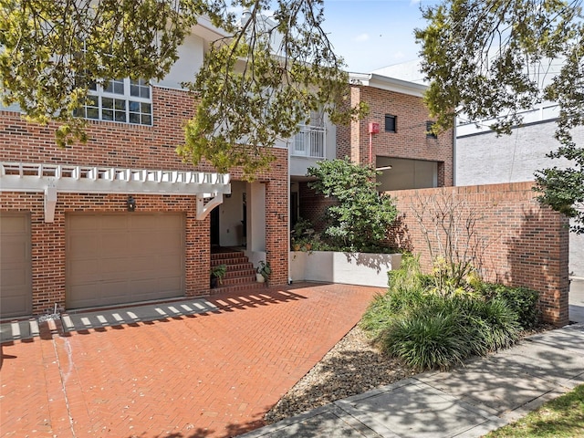 view of front facade featuring brick siding and an attached garage