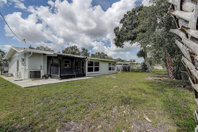 back of house featuring a yard, fence, central AC unit, and a sunroom