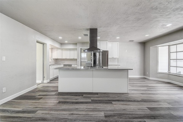 kitchen featuring dark wood-style flooring, a center island, white cabinets, and island range hood