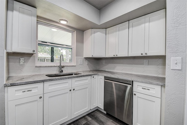 kitchen with dark wood-style flooring, backsplash, white cabinetry, and a sink