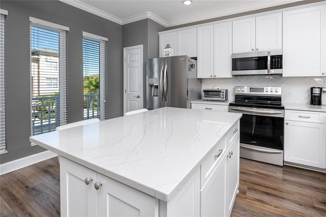 kitchen featuring crown molding, decorative backsplash, appliances with stainless steel finishes, dark wood-style floors, and white cabinets