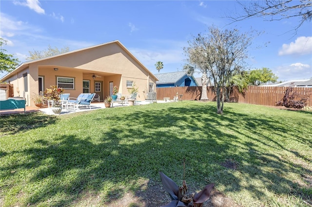 view of yard with ceiling fan, a patio, and a fenced backyard