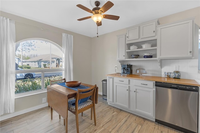 kitchen with open shelves, wood counters, stainless steel dishwasher, light wood-style floors, and baseboards