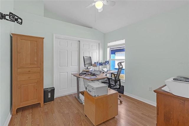 office space featuring baseboards, a ceiling fan, and light wood-style floors