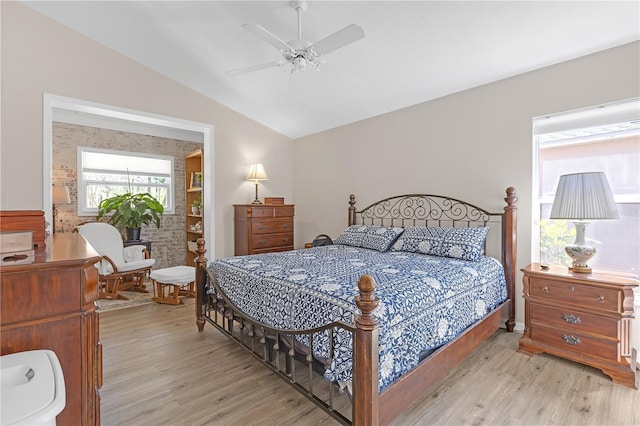 bedroom with light wood finished floors, a ceiling fan, and lofted ceiling