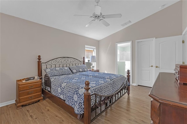 bedroom with vaulted ceiling, baseboards, visible vents, and light wood finished floors