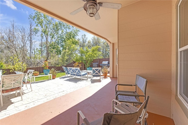 view of patio featuring outdoor dining space, a fenced backyard, and ceiling fan