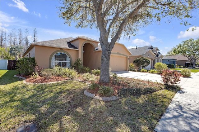 view of front of home with a front lawn, fence, concrete driveway, stucco siding, and a garage