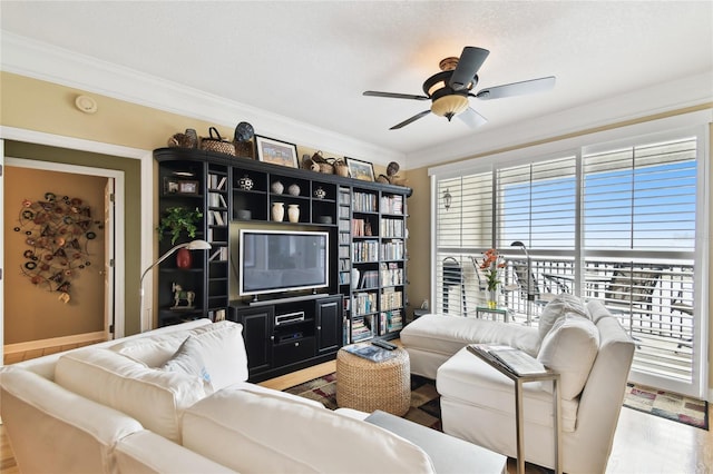 living room featuring ceiling fan, wood finished floors, and ornamental molding