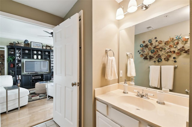 bathroom with visible vents, vanity, and a ceiling fan