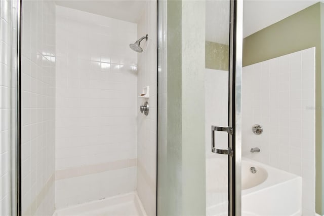 full bathroom featuring a bath and a stall shower