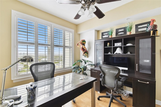 home office with ceiling fan and wood finished floors